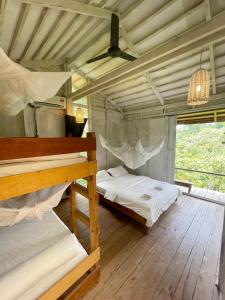 A bunk bed or bunk beds in a room at Paganakan Dii Tropical Retreat