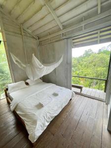 A bed or beds in a room at Paganakan Dii Tropical Retreat