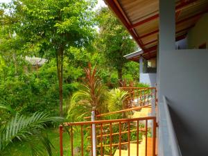 a balcony of a house with trees and plants at Bonus Bungalow in Chalong