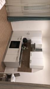 an overhead view of a kitchen with white cabinets at Antico Hotel Moderno in Piombino