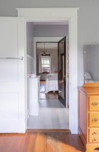 a hallway with a room with a table and a refrigerator at The Manor at Glen Jean Meadows 