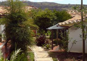 a garden with a gazebo next to a house at Pouso da Chica in Diamantina