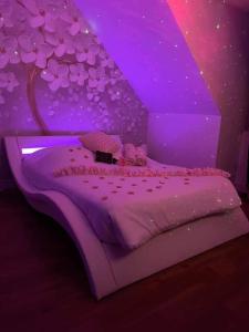 Heaven Loft في إيفتو: غرفة نوم أرجوانية مع سرير عليه شجرة