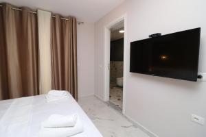 a room with a flat screen tv on a wall at Hercules Room in Himare +56 photos