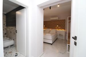 a bedroom with a bed and a bathroom with a sink at Hercules Room in Himare
