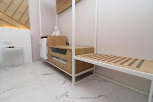 a white room with a shelf and a table at Hercules Room in Himare