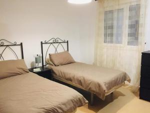a bedroom with two beds and a dresser at Casa Moriarty in Murcia
