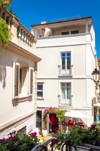 a building with flowers in front of it at REEF Suites in Olbia