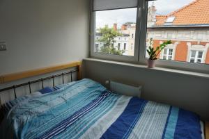Posteľ alebo postele v izbe v ubytovaní Apartamenty Mrongowiusza 12