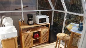 a kitchen with a microwave on top of a table at Aresia in Arès