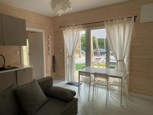 a living room with a table and chairs and a couch at Seaside Harmony in Pogorzelica