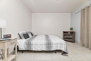 a white bedroom with a bed and a desk at Big Bear Lake Front Lodge in Big Bear Lake