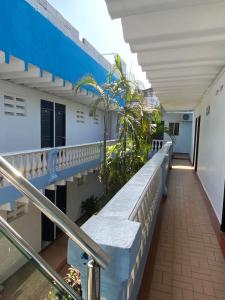 a balcony of a building with a staircase at Hotel Del Mar Inn in Barranquilla