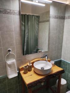 a bathroom with a sink and a mirror at Cozy apartment in Peania (near Airport) in Paianía