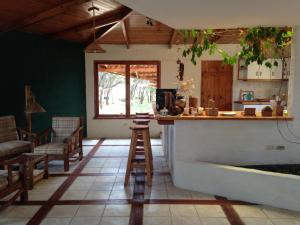a kitchen with a counter and chairs in a room at Vista del Mar Casa y Bungalows in Máncora