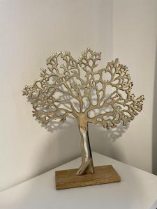 a metal sculpture of a tree on a table at Les Remparts Antibes Location in Antibes