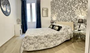 a bedroom with a bed and a wall at Les Remparts Antibes Location in Antibes
