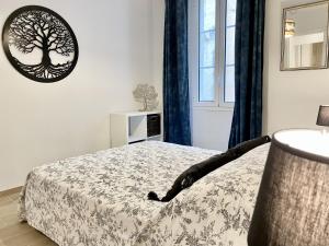 a bedroom with a bed and a window at Les Remparts Antibes Location in Antibes