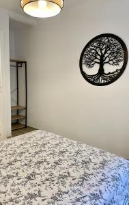 a bedroom with a tree picture on the wall at Les Remparts Antibes Location in Antibes