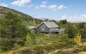 a house on top of a hill in a field at Beautiful Home In Hol I Tjeldsund With Wifi 
