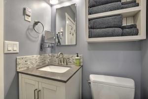 a bathroom with a sink and a toilet and a mirror at Cozy Pittsboro Escape - Hike, Dine, Explore! in Pittsboro +18 photos