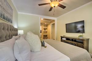 a bedroom with a bed with a ceiling fan and a flat screen tv at Cozy Pittsboro Escape - Hike, Dine, Explore! in Pittsboro