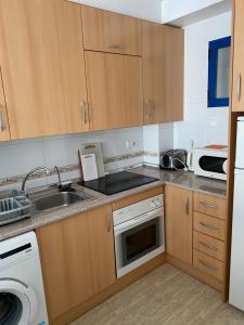 a kitchen with a sink and a dishwasher at Aquamarine home in Campoamor