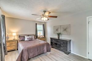 a bedroom with a bed and a ceiling fan at Charming Mountain Home Getaway with Gas Grill! in Mountain Home