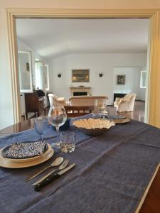 a table with plates and wine glasses on it at Villa Draga by PortofinoVacanze in Santa Margherita Ligure