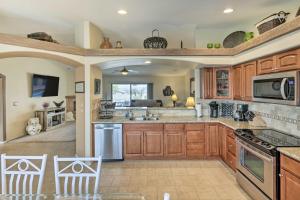 a large kitchen with wooden cabinets and appliances at Arizona Retreat with Casita about 2 Mi to Lake Havasu in Lake Havasu City