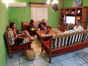 a group of people sitting in a living room at LA MARINA in Ambodifotatra