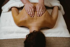 a woman laying on a bed in a towel at The Randolph Hotel, by Graduate Hotels in Oxford