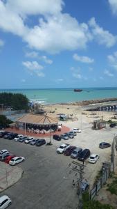 a parking lot next to a beach with cars parked at STUDIO EM FORTALEZA NO CONDOMINIO VILA DE IRACEMA in Fortaleza