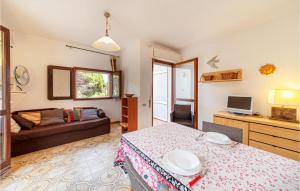 a living room with a table and a couch at 1 Bedroom Awesome Apartment In Stintino in Stintino
