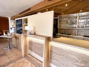 a restaurant with a counter in a room at Adam & Eva Gasthof Paradies mit Hotel in Vogt