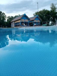 a pool of water with a building in the background at Talian in Pardina