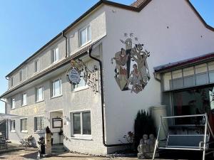 a building with a clock on the side of it at Adam & Eva Gasthof Paradies mit Hotel in Vogt