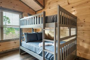 a bedroom with two bunk beds in a cabin at New Dollywood Hills 3 Bdrm-game room-hot tub-grill in Sevierville