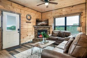 a living room with a couch and a fireplace at New Dollywood Hills 3 Bdrm-game room-hot tub-grill in Sevierville