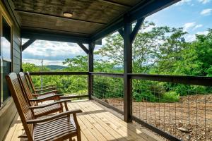 three chairs on a porch with a view of trees at New Dollywood Hills 3 Bdrm-game room-hot tub-grill in Sevierville