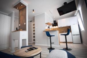 a living room with two blue chairs and a table at Pstrowskiego 13 in Olsztyn