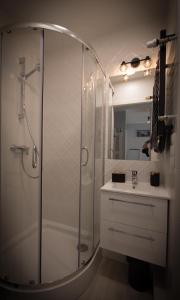 a bathroom with a shower and a sink at Pstrowskiego 13 in Olsztyn