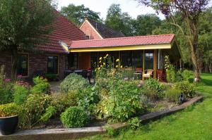 a house with a garden in front of it at B&B De Mersken in Ureterp +12 photos