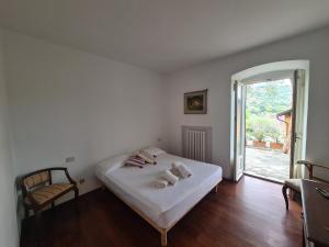 a bedroom with a white bed and a window at Villa Draga by PortofinoVacanze in Santa Margherita Ligure