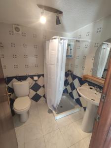 a bathroom with a toilet and a sink at Alojamiento para vocaciónes in Rasines
