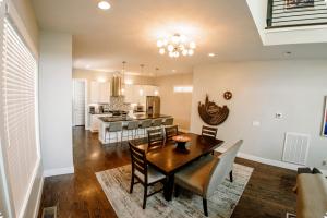 a dining room and kitchen with a table and chairs at Huge4bedr10mintodtownsafe in Nashville