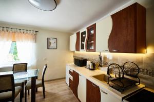 a kitchen with a sink and a table with a dining room at Apartament Szczecinek - Spokojna okolica in Szczecinek