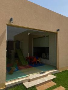 een groot glazen raam van een huis met een speeltuin bij Arabs Chalet in Buraydah