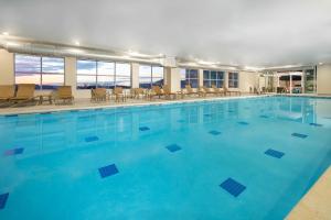 a large swimming pool with blue water at Hyatt House Lewes Rehoboth Beach in Lewes