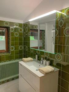 a bathroom with a sink and a mirror at Landhaus Gappmaier in Zell am See